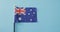 Close up of australian flag with stars and stripes lying on blue background