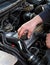 Close up of auto mechanic opens the oil cap