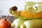 Close-up autumn onions and corn on a wooden thanksgiving table, white brick backdrop, selective focus