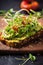 Close-up avocado toast with microgreens and a sprinkle of chili flakes