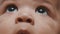 Close up baby eyes. Beautiful dark skin newborn face expression