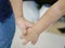 Close up of baby girls, siblings, holding each other hands