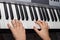 Close up of baby`s hands playing the piano. Hands of a child playing the keyboard of a synthesizer. A closeup image of a baby`s