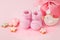 Close up of baby shoes, baby shower decoration - sweetness and baby booties on pink background, first newborn party background,