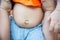 Close up baby stomach show his navel and belly. Flatulence in babies concept. Health and eating in Babies concept.