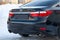 Close-up of the back of the car body Lexus es black sedan with the symbols of the Japanese manufacturer on the trunk in the street