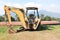 Close up of a Back Hoe at the side of a hill