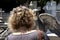 Close-up of the back of an unrecognizable woman visiting some tombs