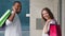 Close-up back view multiracial couple multiethnic family african man and caucasian woman carry shopping bags packages