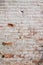 Close up background of brick wall, different shape adobe, vertical rough abstract shabby old worn surface texture