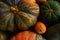 Close up background of red and green pumpkins on dark wood