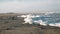 Close-up background of thick white sea foam shaking under strong wind at North sea beach on clear sunny day slow motion.