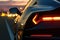 Close up on backlight of a generic unbranded sport car at sunset, generative ai illustration