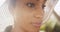 Close up backlit shot of beautiful Black woman wearing sunhat wi