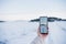 close up of backpacker woman hiking in snowy mountain taking a picture of landscape with mobile phone.winter season. nature and