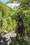 Close-up of backpacking woman standing in dense Pyrenees forest