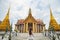 Close up backside portrait young Asian woman standing in front of The golden church inside Wat Phra Kaew