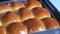 Close up of baked bread and apply butter on top by using kitchen brush with melted butter. Butter was melted and flow on the bread