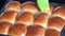 Close up of baked bread and apply butter on top by using kitchen brush with melted butter. Fresh homemade of plain bread