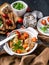 Close-up baked potatoes with chicken meat and carrots, sandwiches with cheese and cherry tomatoes on a dark wooden background