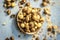 Close up of baked or roasted chickpea/channa or dalia in a bowl on a blue surface.