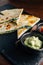 Close up Baked Spinach and Cheese Quesadillas served with Salsa and Guacamole