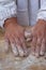 Close-up of baker hands rolling a dough: preparation of raw homemade small italian dumplings