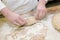 Close-up. Baker makes baked goods, shapes dough on the desktop