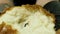 Close up of baker man hands tear hot bread isolated on black background. Stock footage. Cook male hands in black gloves