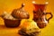 Close up on baklava served on oriental small plate, tea and sugar bowl in the background