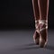 Close up of ballerina legs in pointes ober gray