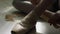 Close-up of ballerina`s feet. Close-up of calloused, bandaged with patches, feet ballerina sitting on floor and