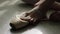 Close-up of ballerina`s feet. Close-up of calloused, bandaged with patches, feet ballerina sitting on floor and