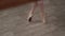 Close-up of a ballerina`s feet on pointe shoes, taking steps and stretching her feet before class