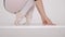 Close up of a ballet dancer`s feet in white studio