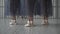 Close-up of ballet dancers legs in pointe shoes, tights and mesh skirt training in the choreography room on the wooden