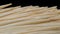 Close up of bamboo toothpicks on a dark background. Video background