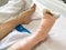 Close-up bandaged of asain woman patient leg lying on hospital b