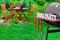 Close-up Of Barbecue Grill With Tools And BBQ Party Sign