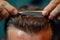 Close-up of a barber\\\'s skilled hands crafting a perfect hairstyle