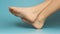 Close up of bare child feet on blue background.