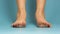 Close up of bare child feet on blue background.