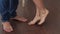 Close-up of the bare feet of a loving couple on the floor near the window.