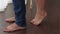 Close-up of the bare feet of a loving couple, the girl stands on her toes.