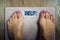 Close up of bare female feet standing on bathroom scale. Concept of shaping and wellness. Time to loose weight. Woman finds out