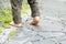 Close up of the bare foot of the child walking on stone pavement and copy space