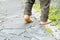 Close up of the bare foot of the child walking on stone pavement and copy space