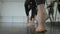 Close-up barefoot legs of female ballet dancer moving in slow motion. Unrecognizable Caucasian young woman rehearsing in