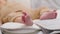 Close up barefoot of newborn baby lying on baby bed relax and comfortable.Infant Baby tiny feet moving on bed at home.Newborn Baby