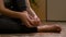 Close-up of barefoot young woman massaging her sprained foot having painful symptoms